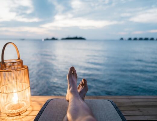Feet of a person relaxing by the sea