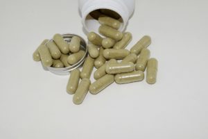 a handful of green capsules