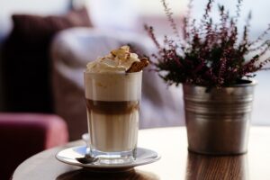picture of a cappuccino next to a plant
