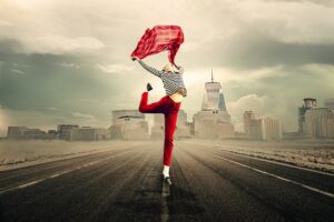 A young woman dancing alone in the middle of the road