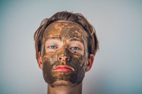 Young man with a face mask for acne