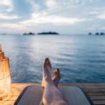 Feet of a person relaxing by the sea